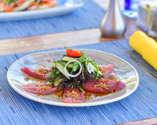 Appetizer with yellow napkin and blue placemat