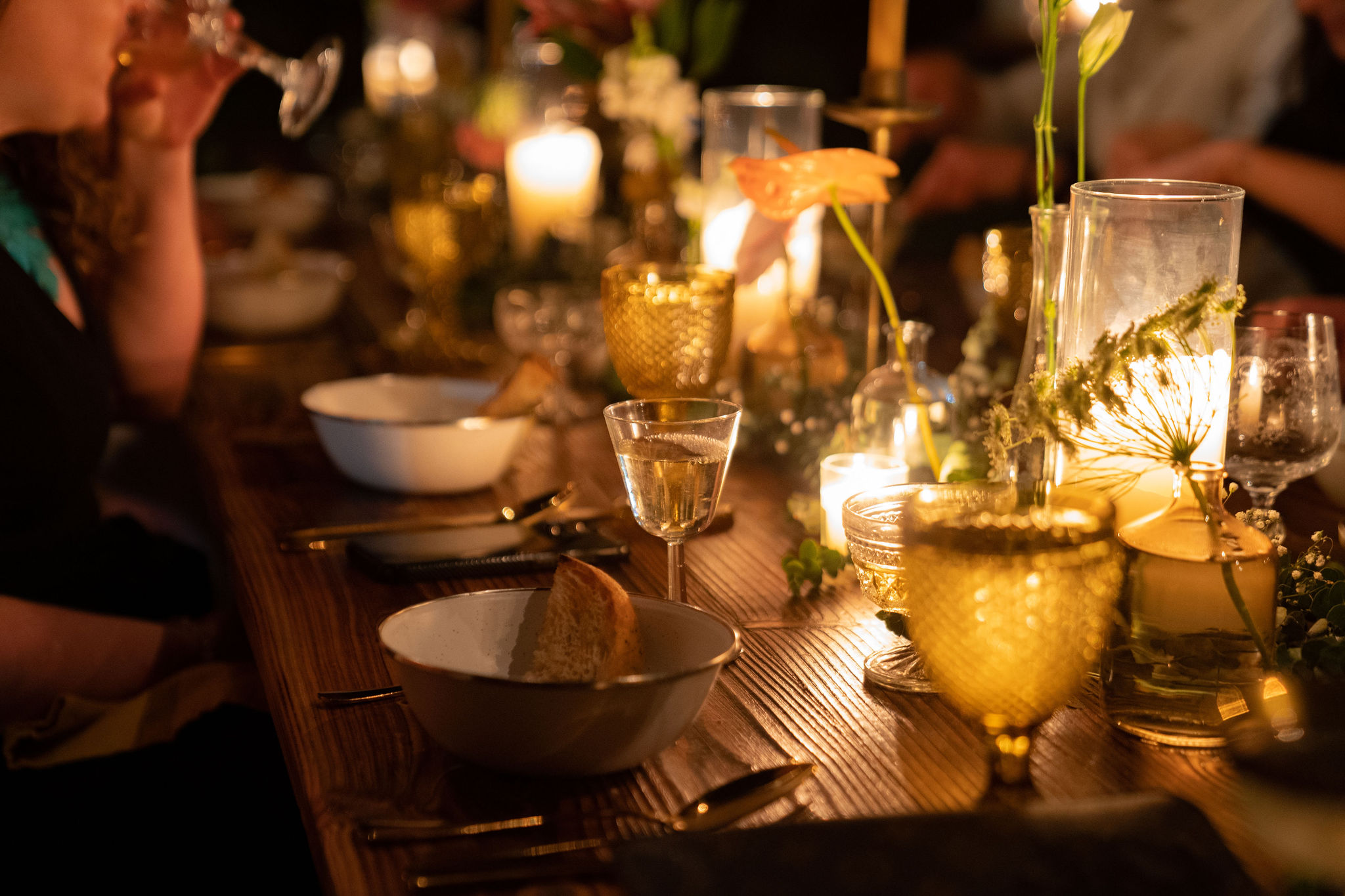 Wooden tables were set with candles and cutlery