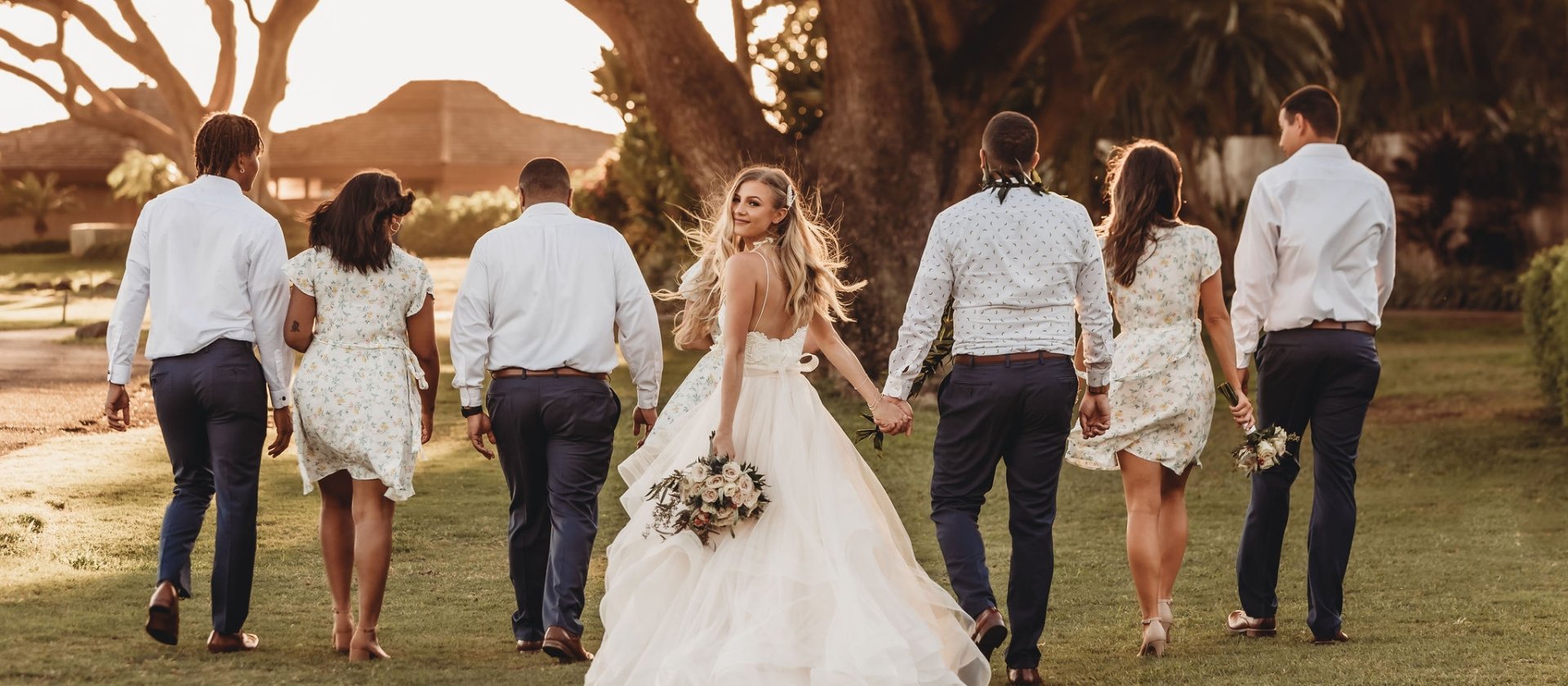 newly weds walking with bridal party