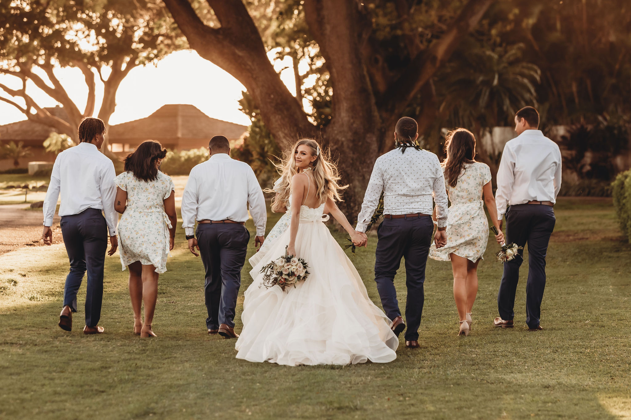 newly weds walking with bridal party