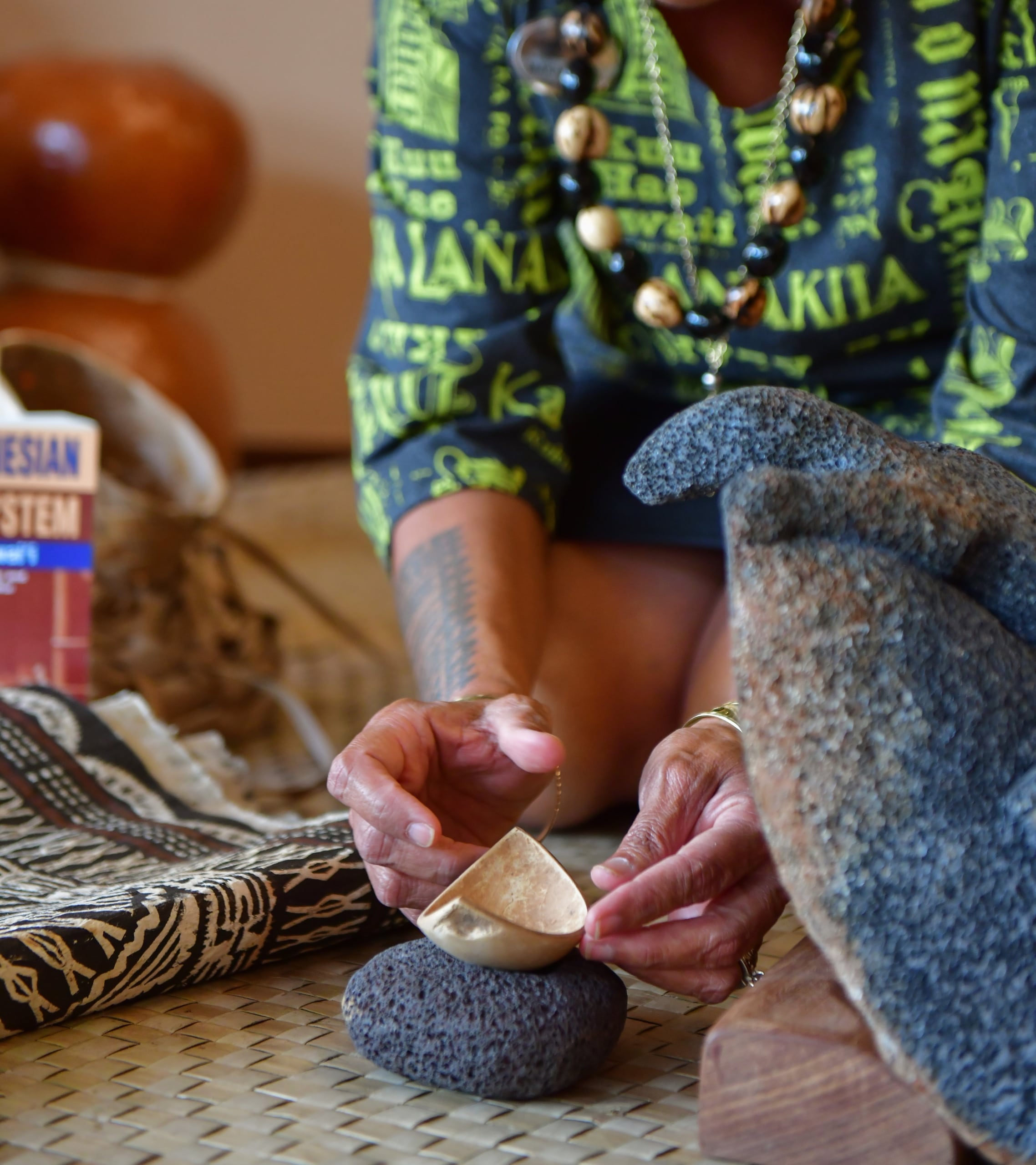 Woman with rock and coconut husk
