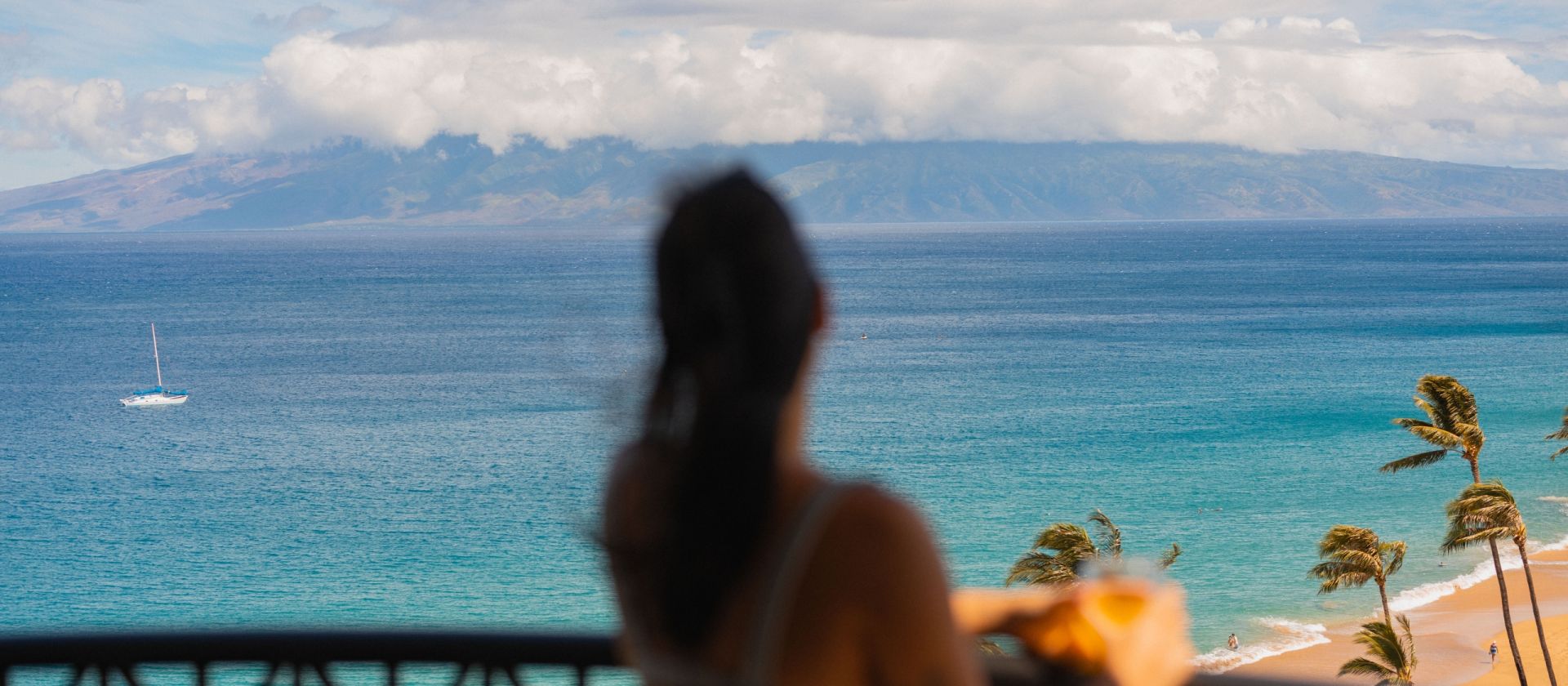 Woman looking over the ocean from private lanai