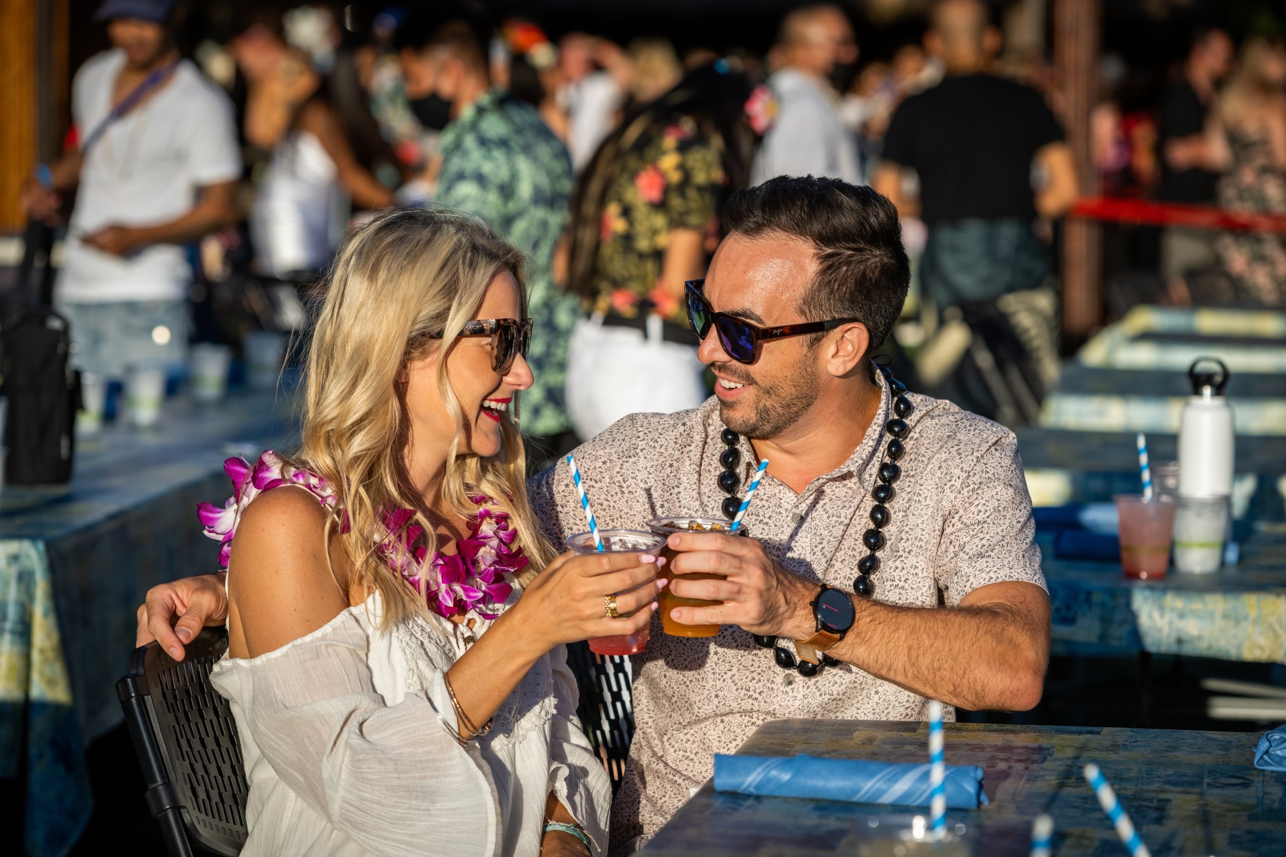 Couple enjoying drinks at the luau
