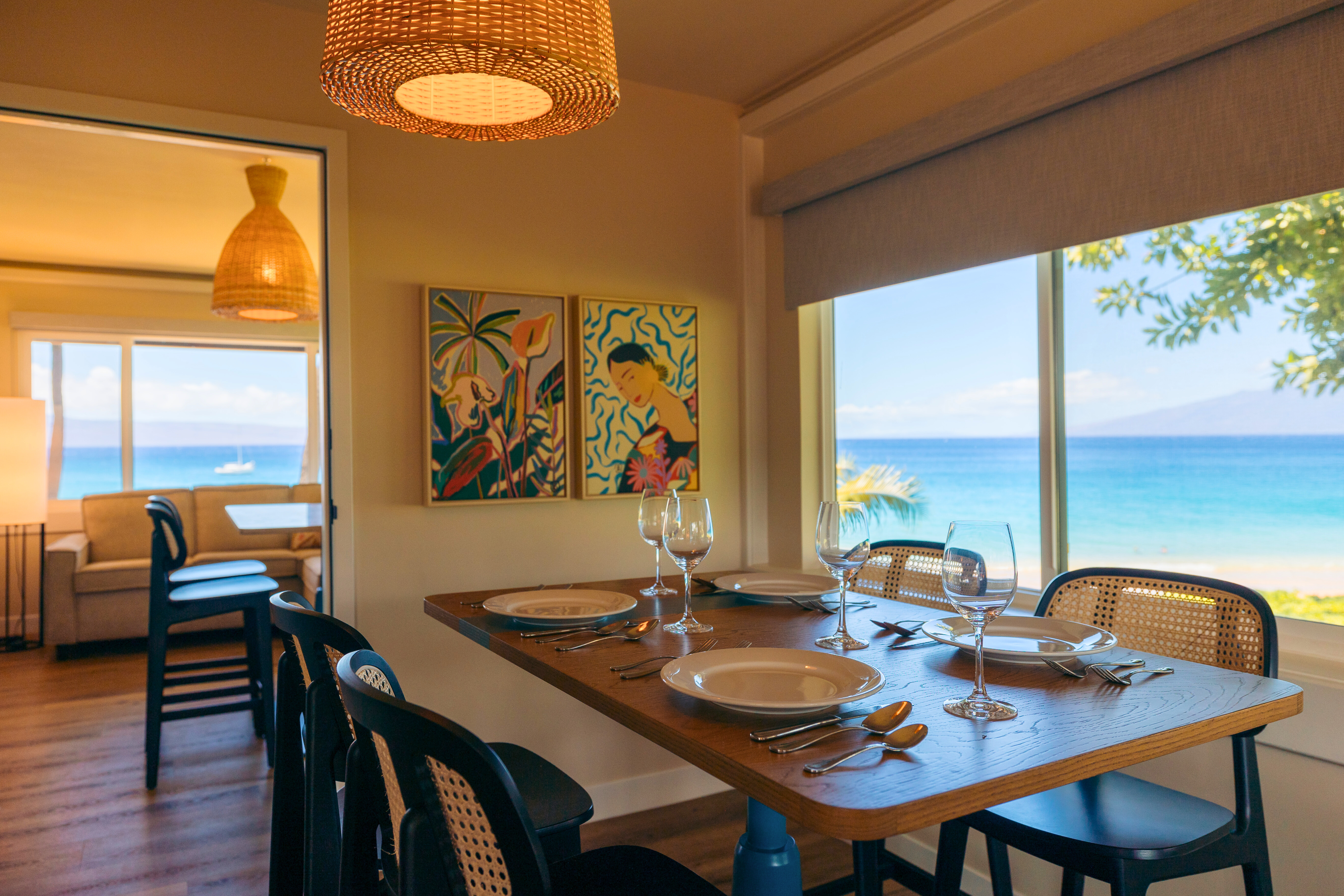 A dining table set for a meal with a view of the ocean
